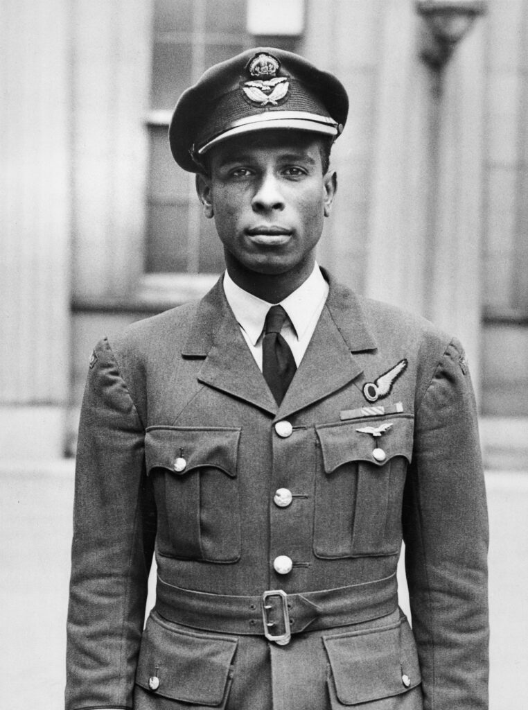 Black and white image of Flight Lieutenant Ulric Cross in military uniform, taken post-award ceremony at Buckingham Palace, 1945.